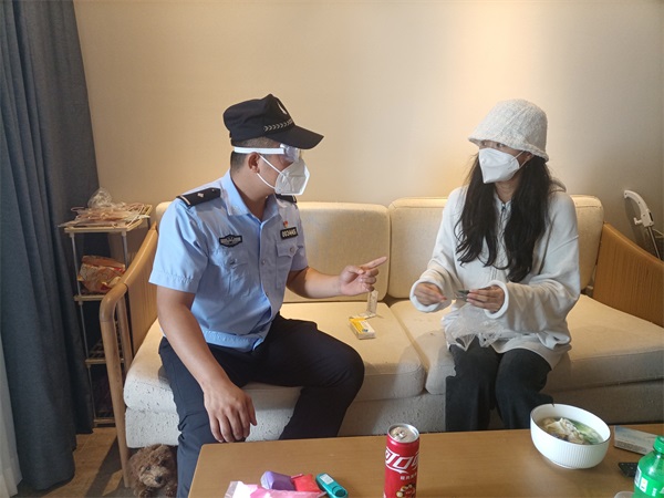 图为新梅海岸派出所民警给刘女士送药并鼓励刘女士积极健康生活
