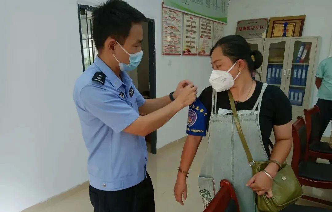 （民警给网格员佩戴袖章）