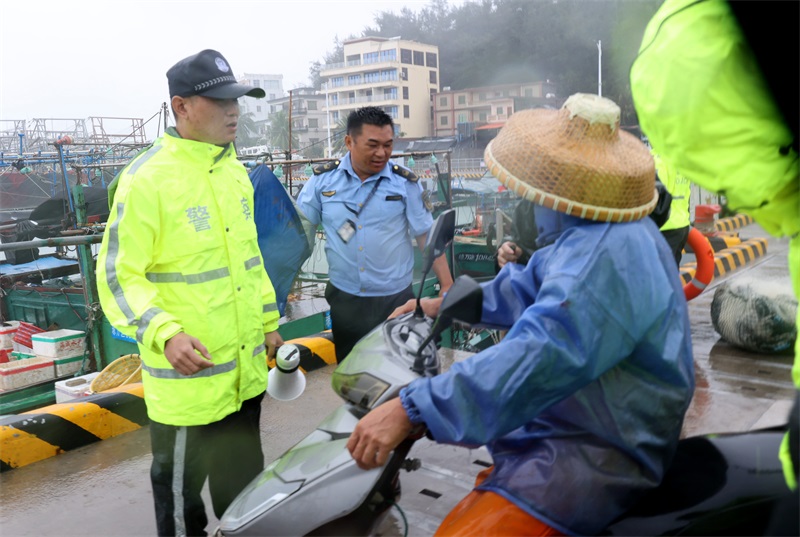 乌场海岸派出所和万宁综合行政执法局工作人员及时规劝在港口内停留的渔船民离港避风雨。代龙超摄